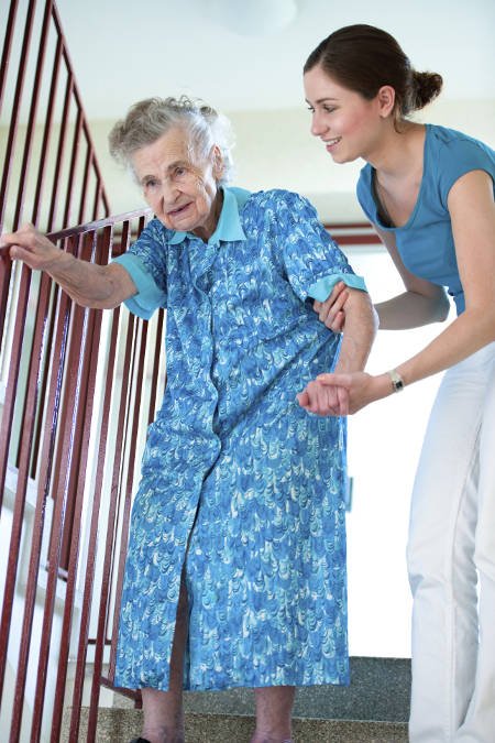 caregiver-with-elderly-woman-on-stairs